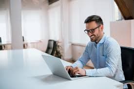 Two men discussing on laptop